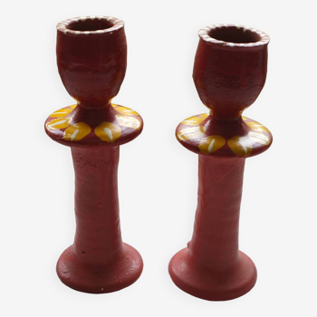 A pair of glazed earthenware candlesticks.