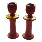 A pair of glazed earthenware candlesticks.