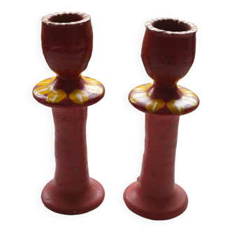 A pair of glazed earthenware candlesticks.