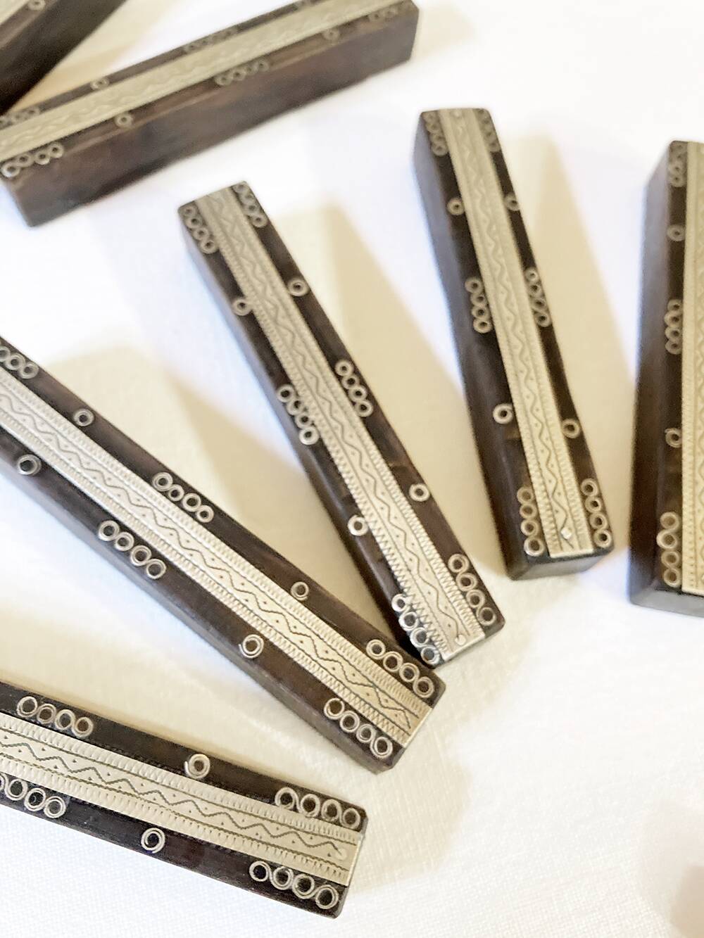 Set of 11 ebony wood knife rests with brass inlay