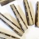 Set of 11 ebony wood knife rests with brass inlay