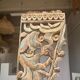 Indonesian construction element in carved wood with intertwined plant motifs mounted on a base (fri