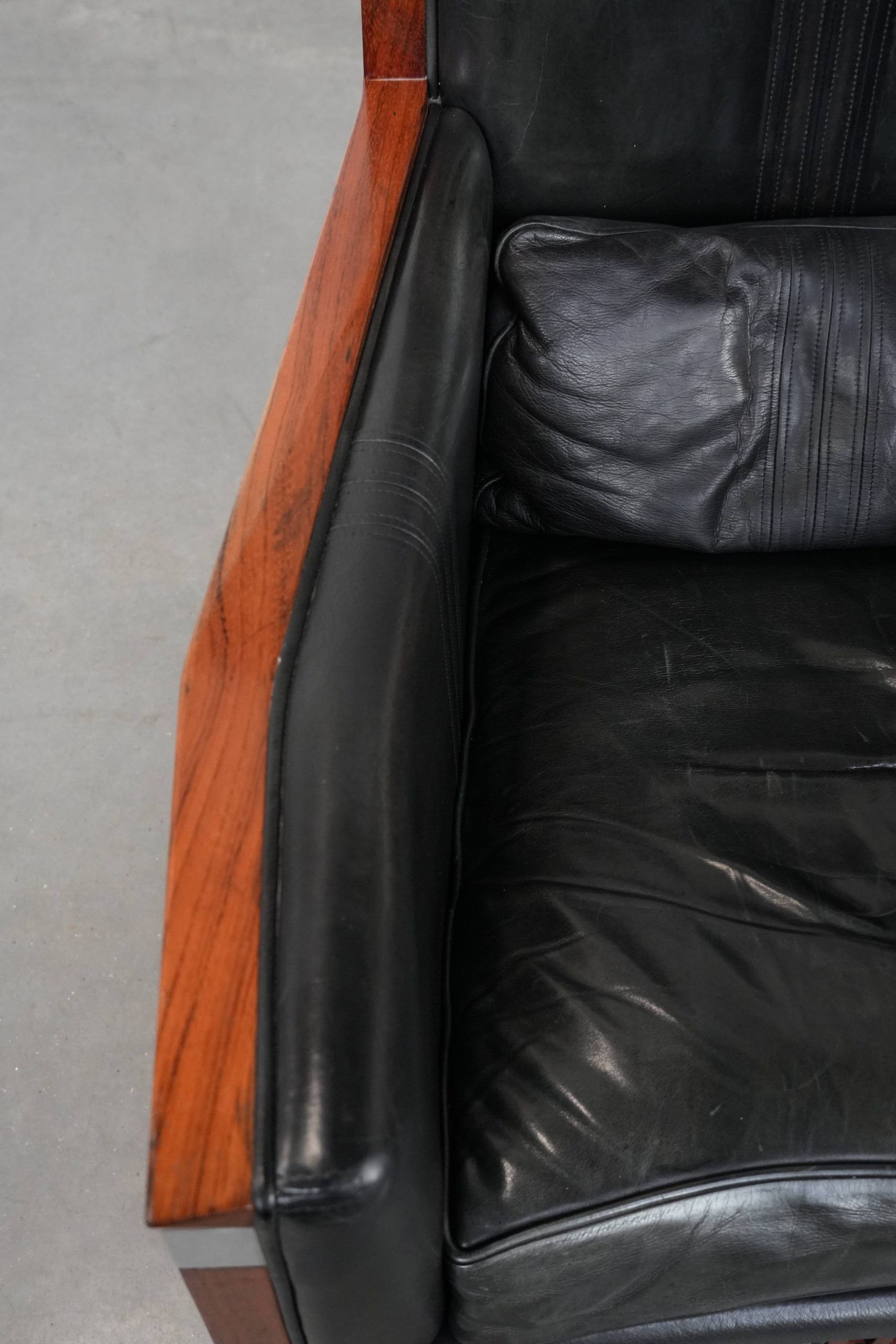 Black cowhide leather and wooden Art Deco design armchair