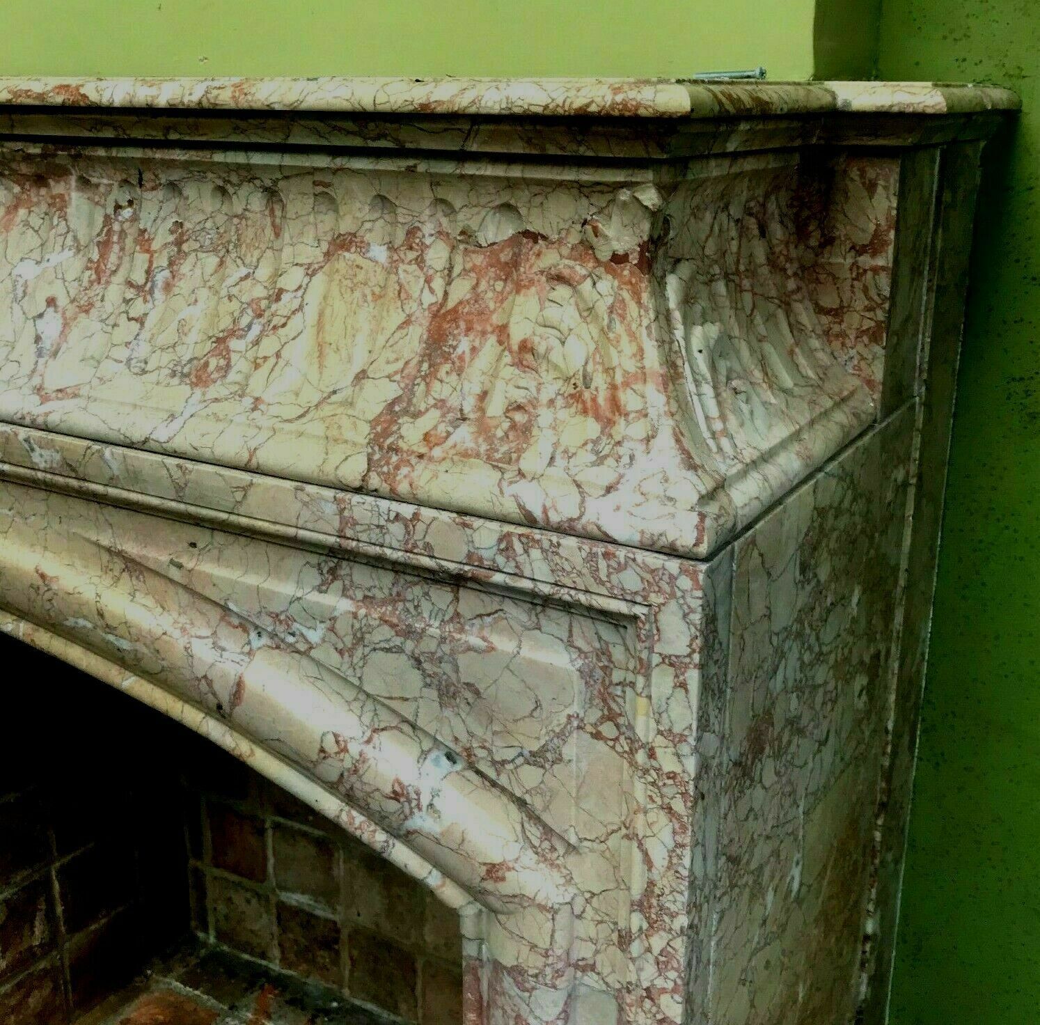 Louis XIV-style fireplace has 19th century veined pink marble hood