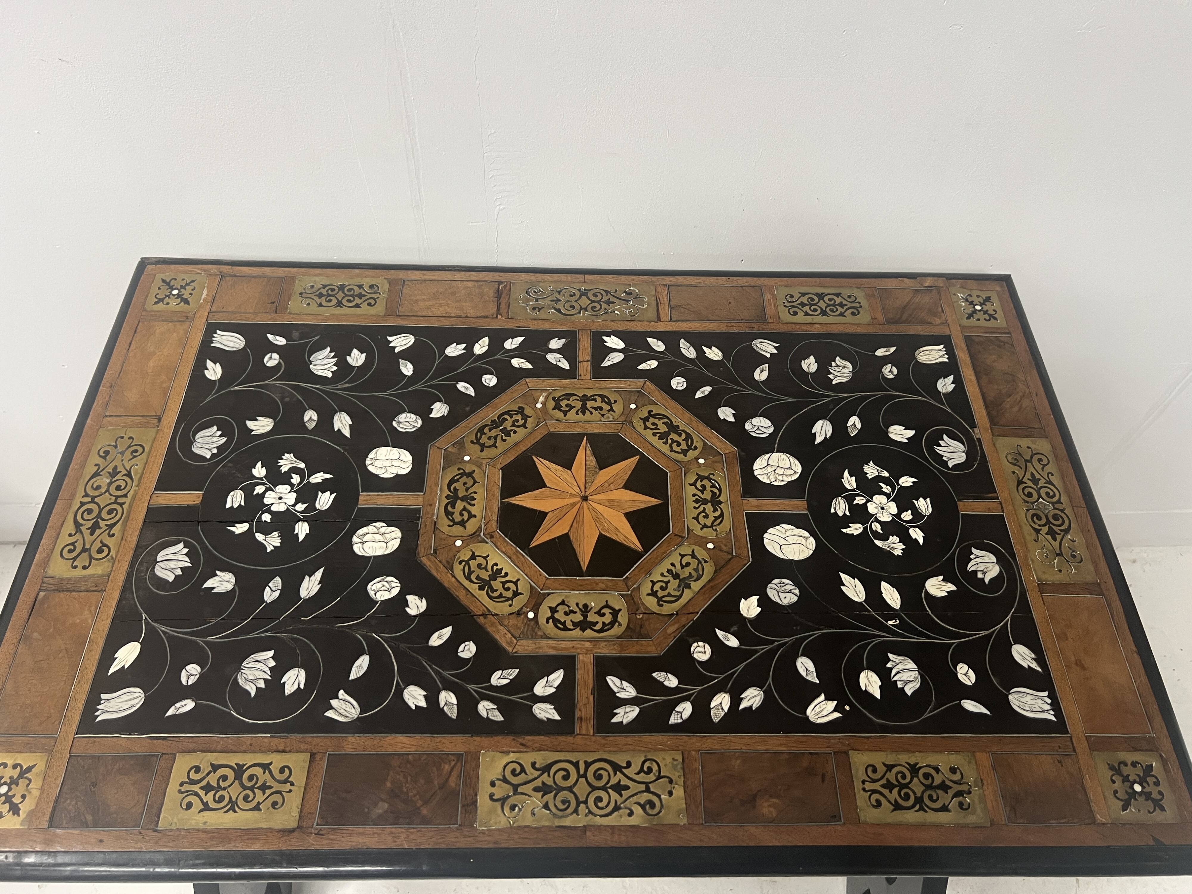 Blackened wood display table with marquetry top, Spain, 19th century.