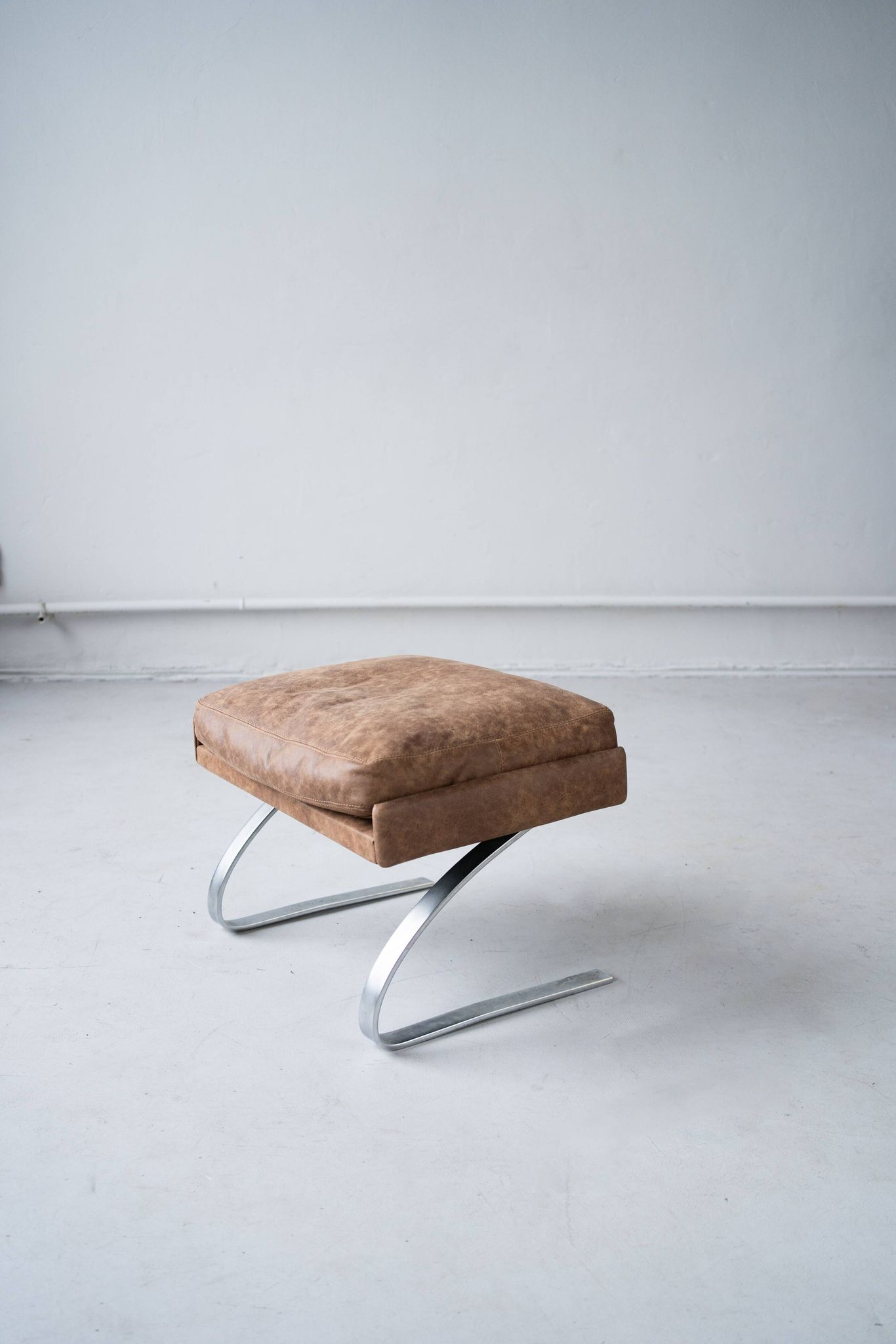 Vintage swing armchair and stool in leather by reinhold adolf for cor, 1970s, set of 2