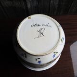 Vintage ceramic pot with hand-painted floral decoration.
