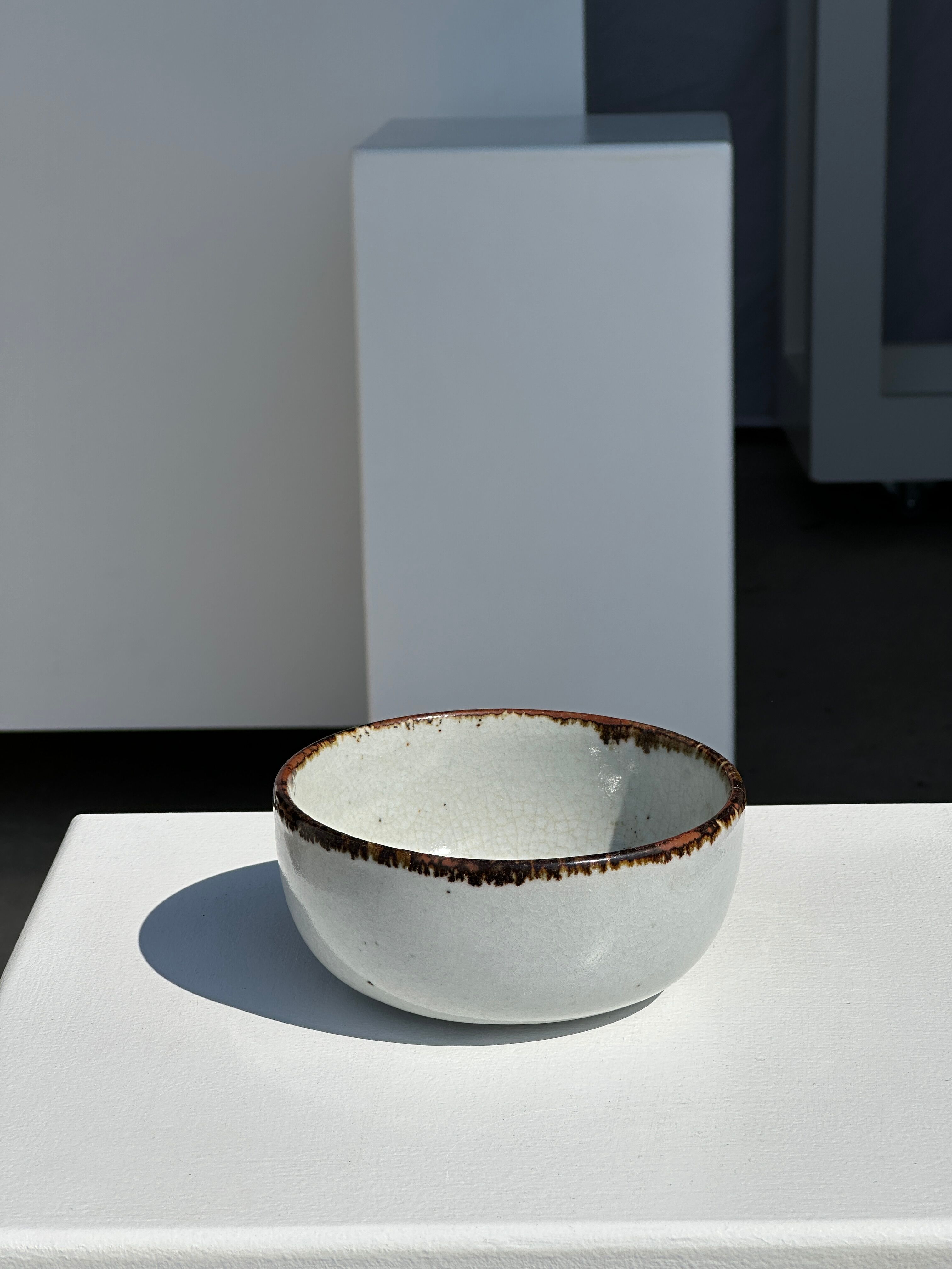 Small white glazed ceramic bowl black edges