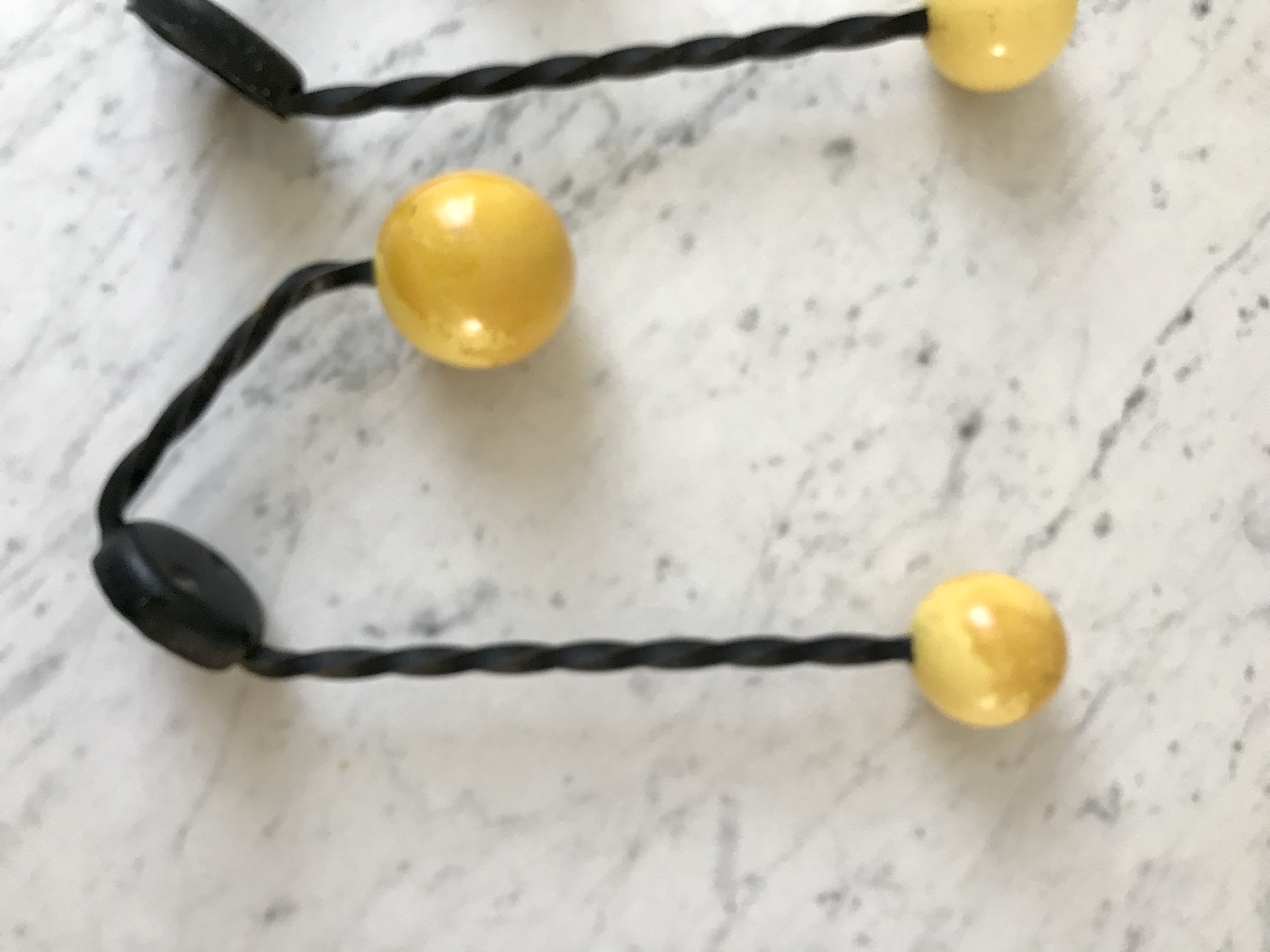 Duo of hooks balls in yellow wood and black iron 60s