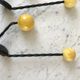 Duo of hooks balls in yellow wood and black iron 60s