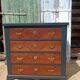 Vintage commode revamped in matte black & wood with warm tones.