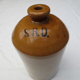 Old wiskhey jug in sand