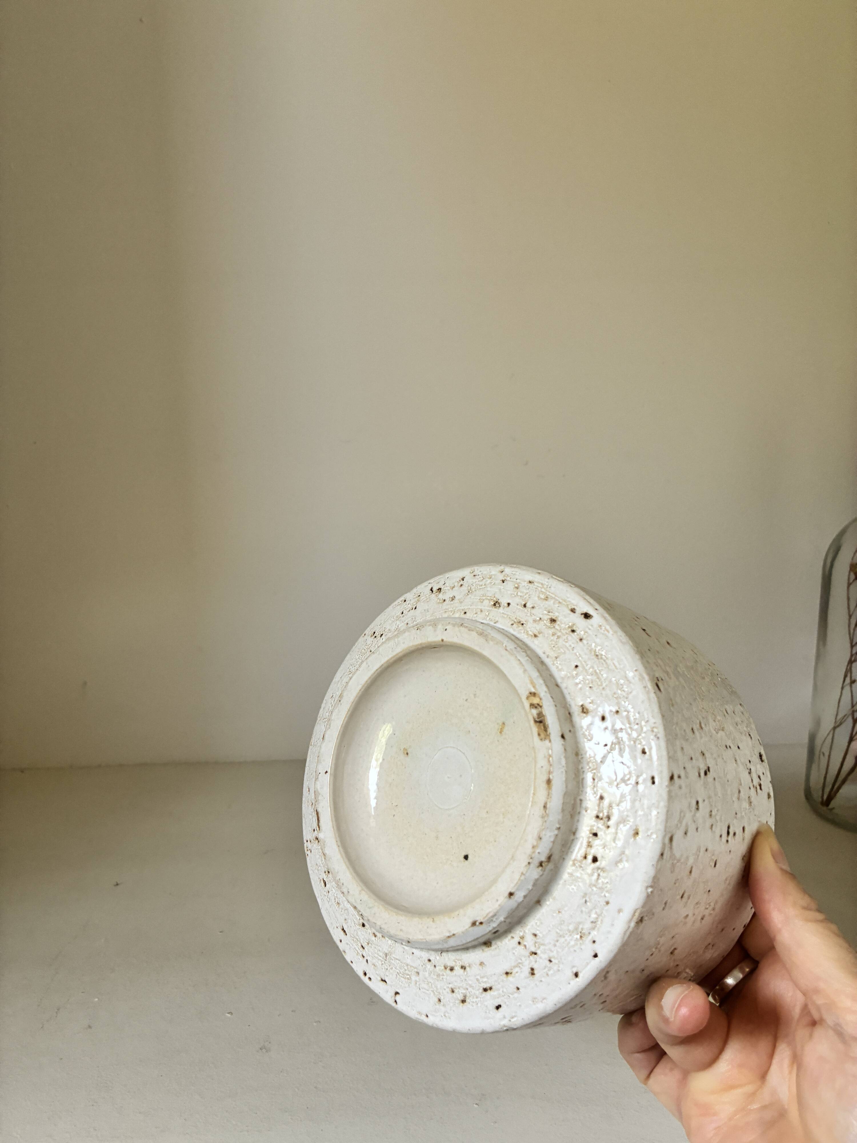 White ceramic vase with a textured effect.