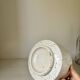 White ceramic vase with a textured effect.