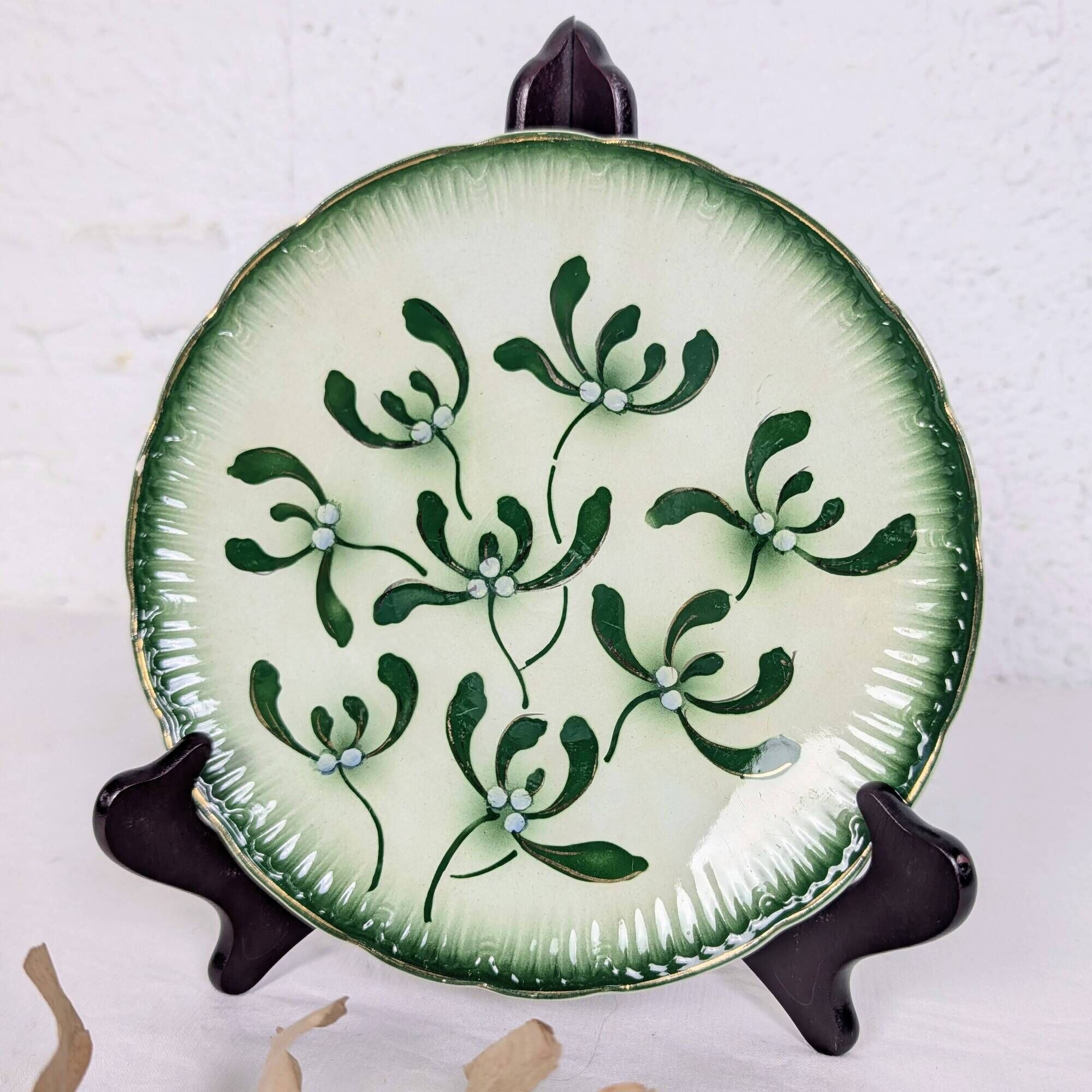Badonviller plate with a guilloche pattern, green slipware.