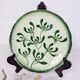 Badonviller plate with a guilloche pattern, green slipware.