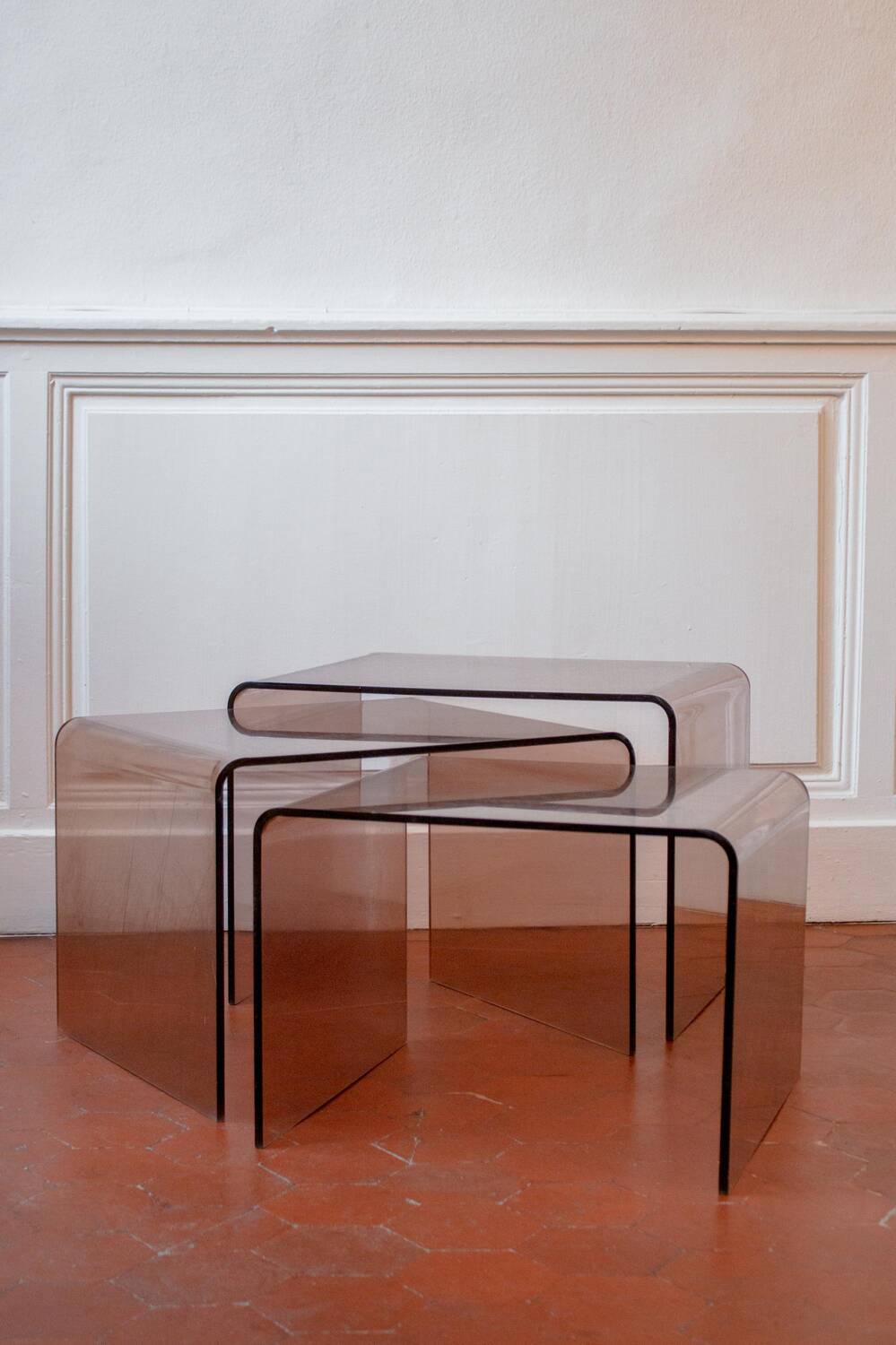 Vintage trio of nesting tables in smoked plexiglass by Michel Dumas, year.