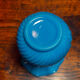 Blue opaline vase, opaque glass, wavy neck/rim, relief decoration of a bow.