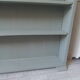 Vintage shallow bookcase, re-enchanted in gray green, wooden tray.