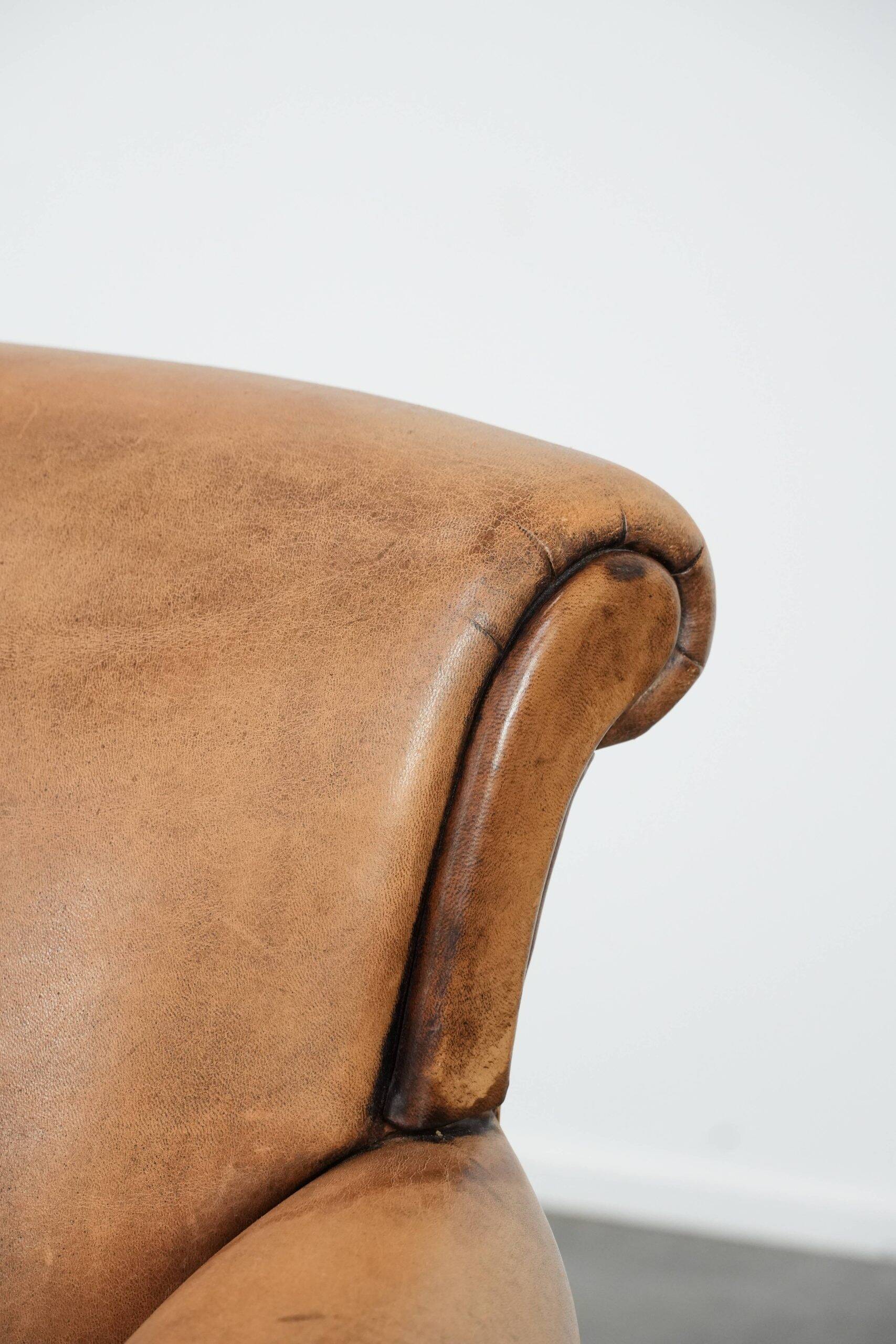 Vintage sheepskin armchair with a beautiful light colour and elegant legs