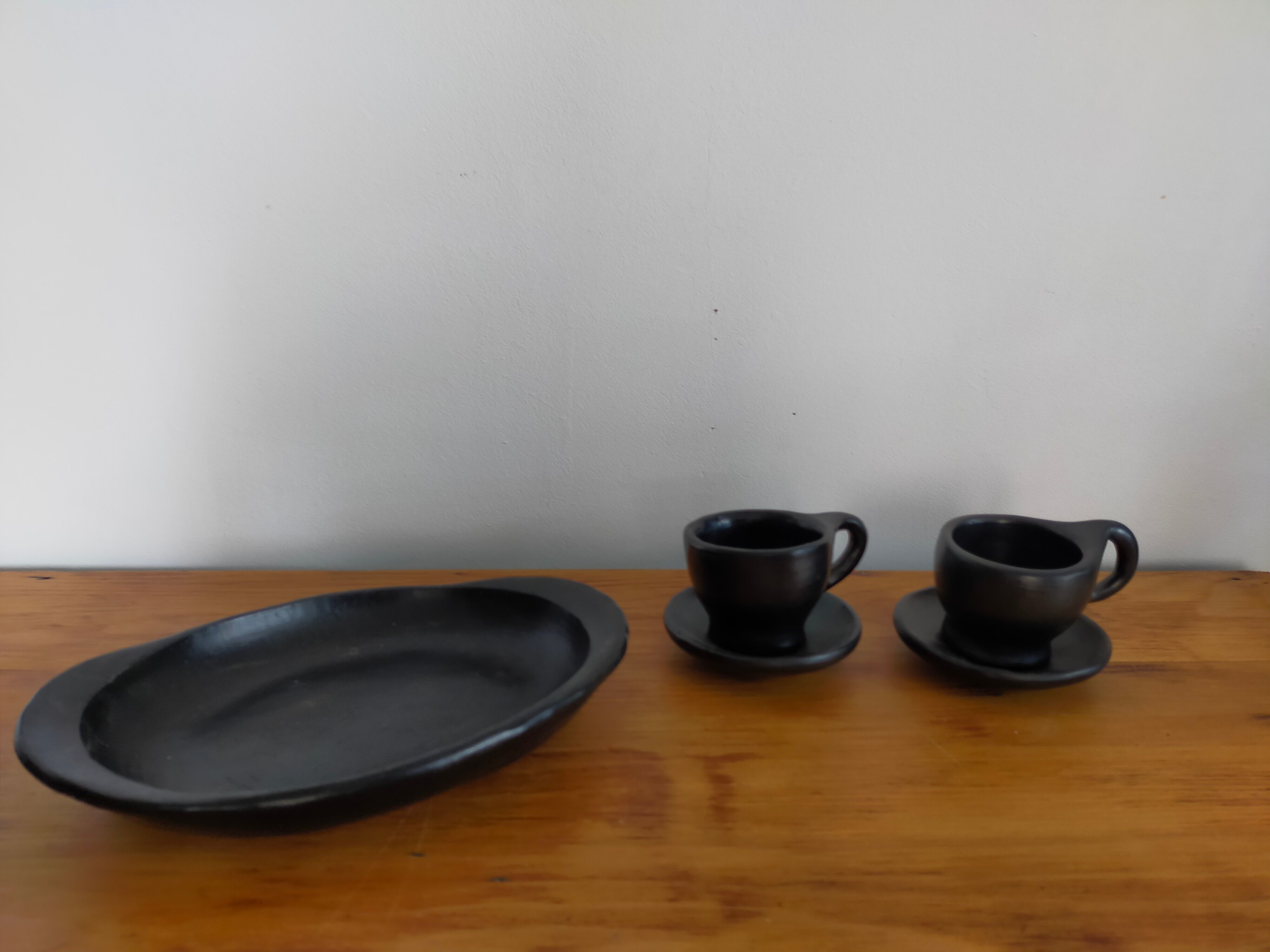 Terracotta service painted in black saucer cups and top