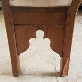 Church bench in fir tree with armrests