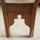 Church bench in fir tree with armrests
