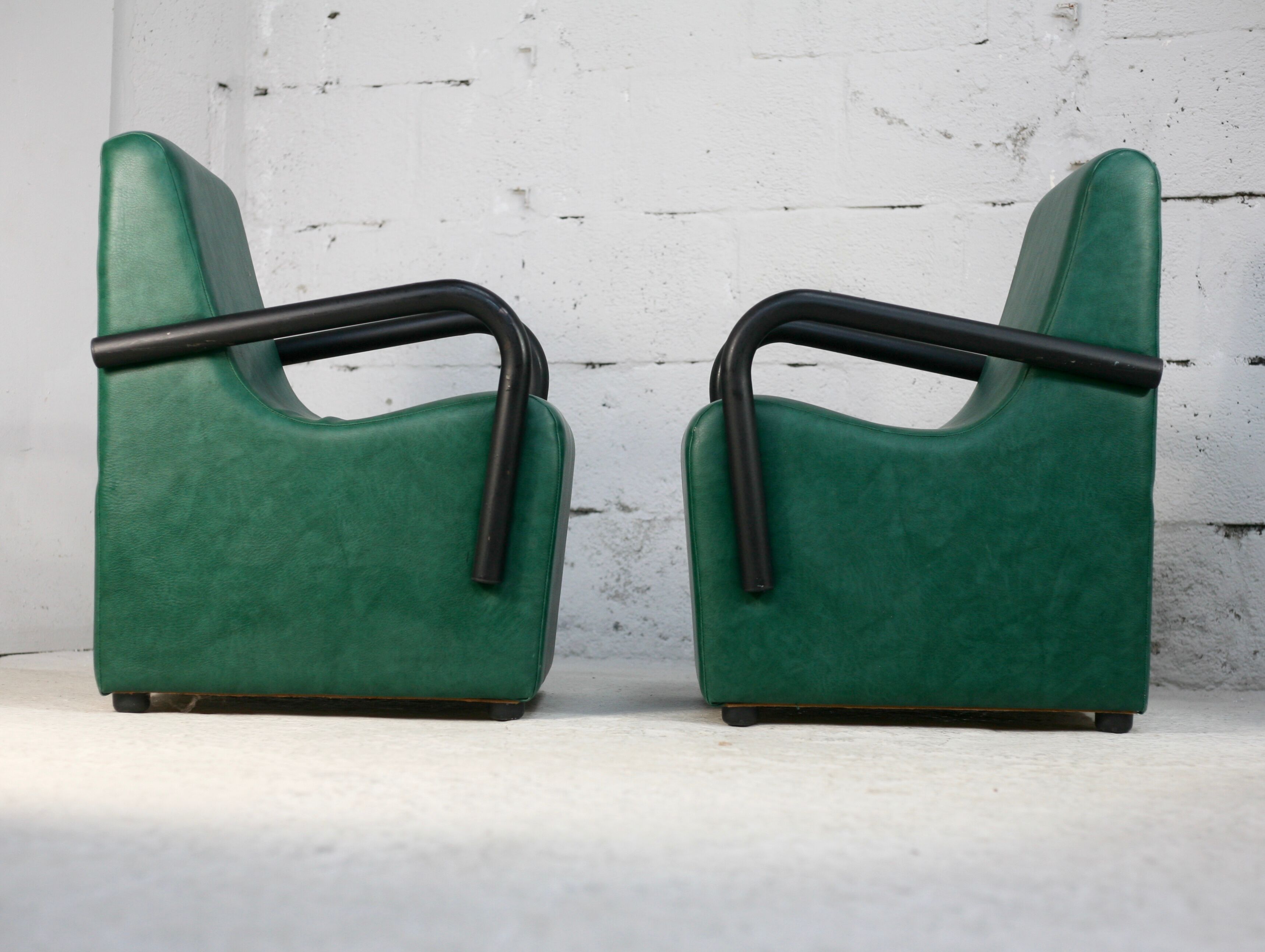 Pair of armrest heaters. Steel and green imitation leather. France, circa 1980