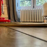 Antique oval beveled mirror adorned with tassels