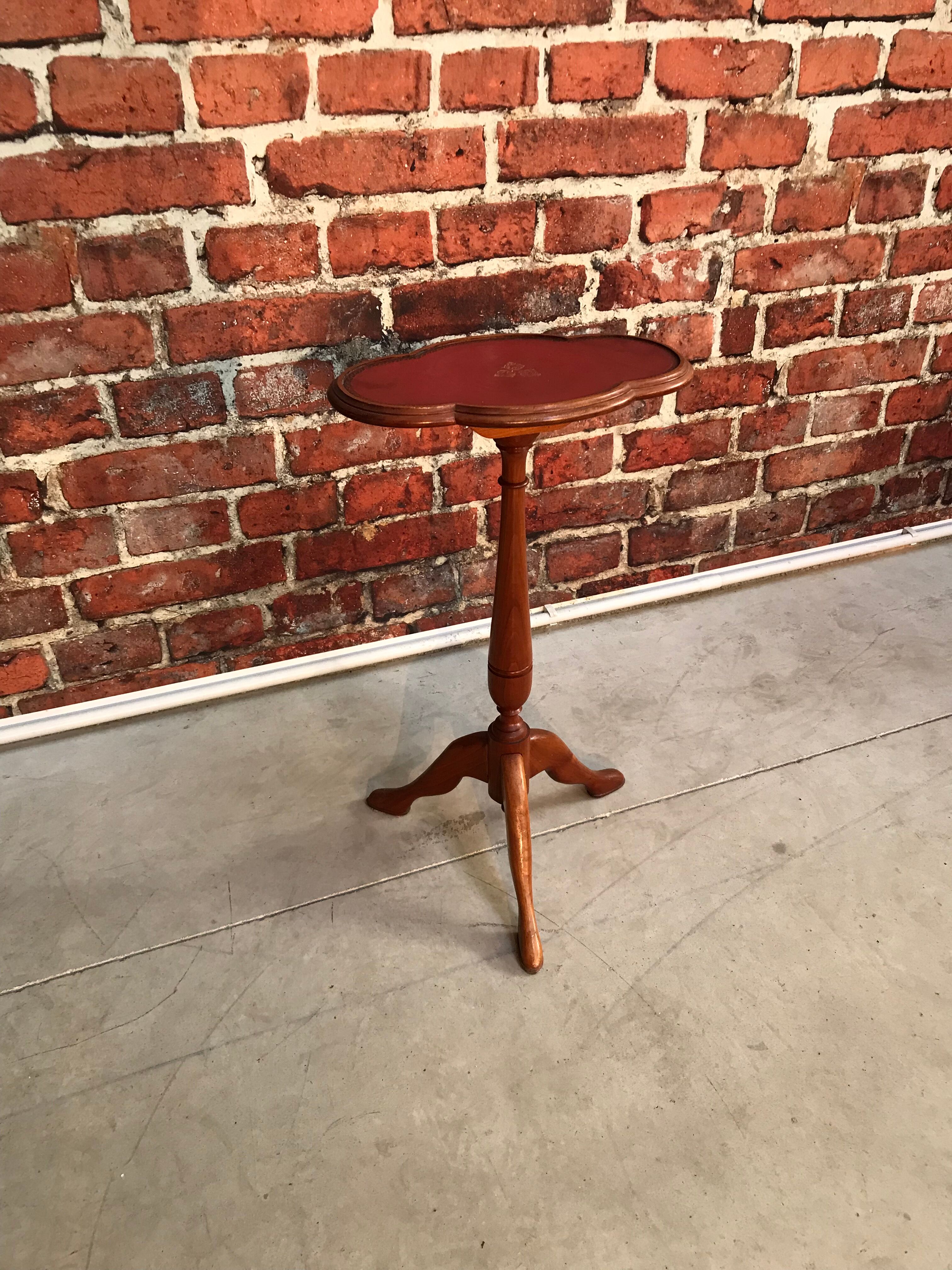 Wooden pedestal table red leather top