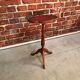 Wooden pedestal table red leather top