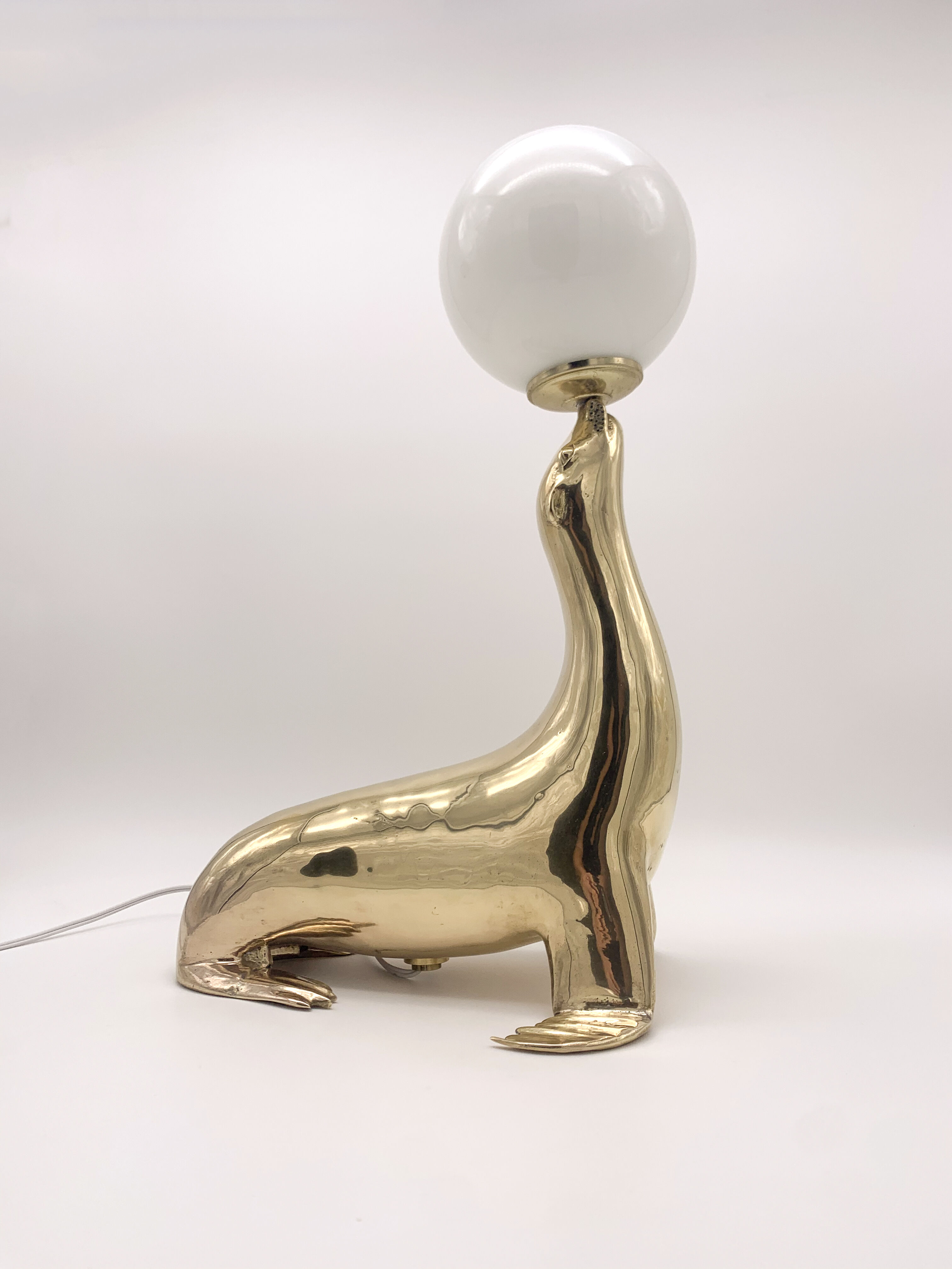Vintage brass sea lion lamp