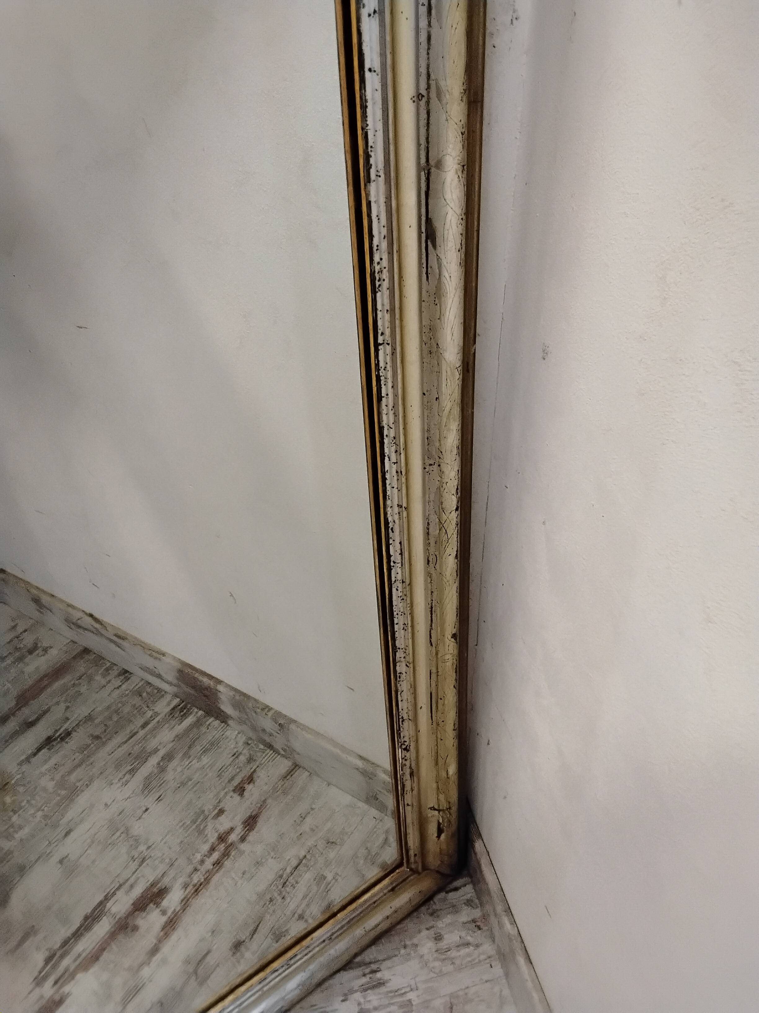 Antique mirror with a gilded frame and cherubs.