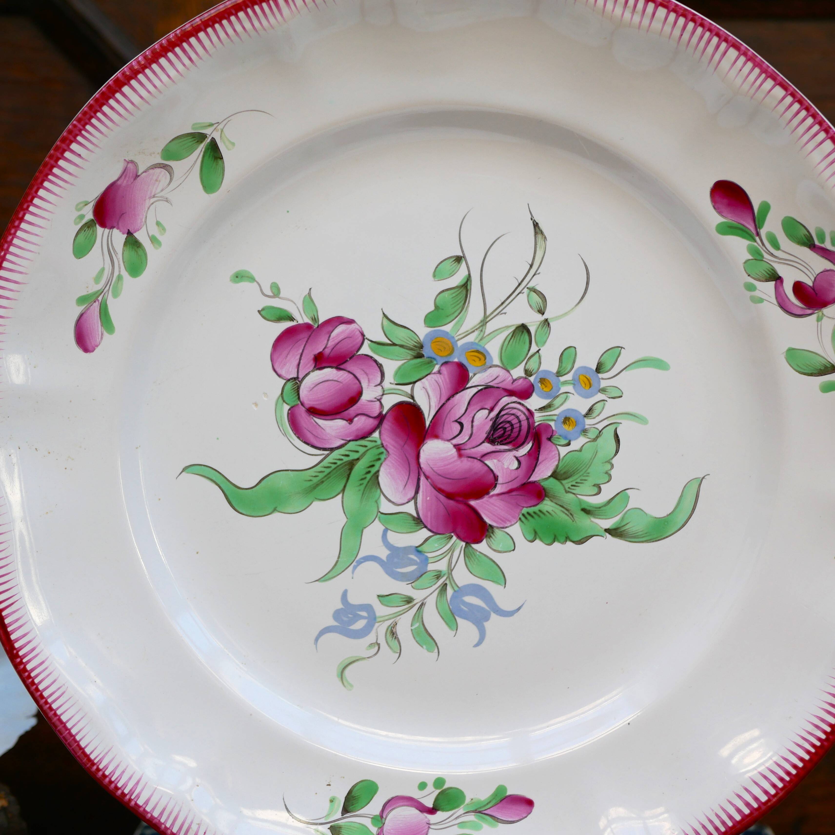Three small hand-painted Saint-Clément dinner plates.