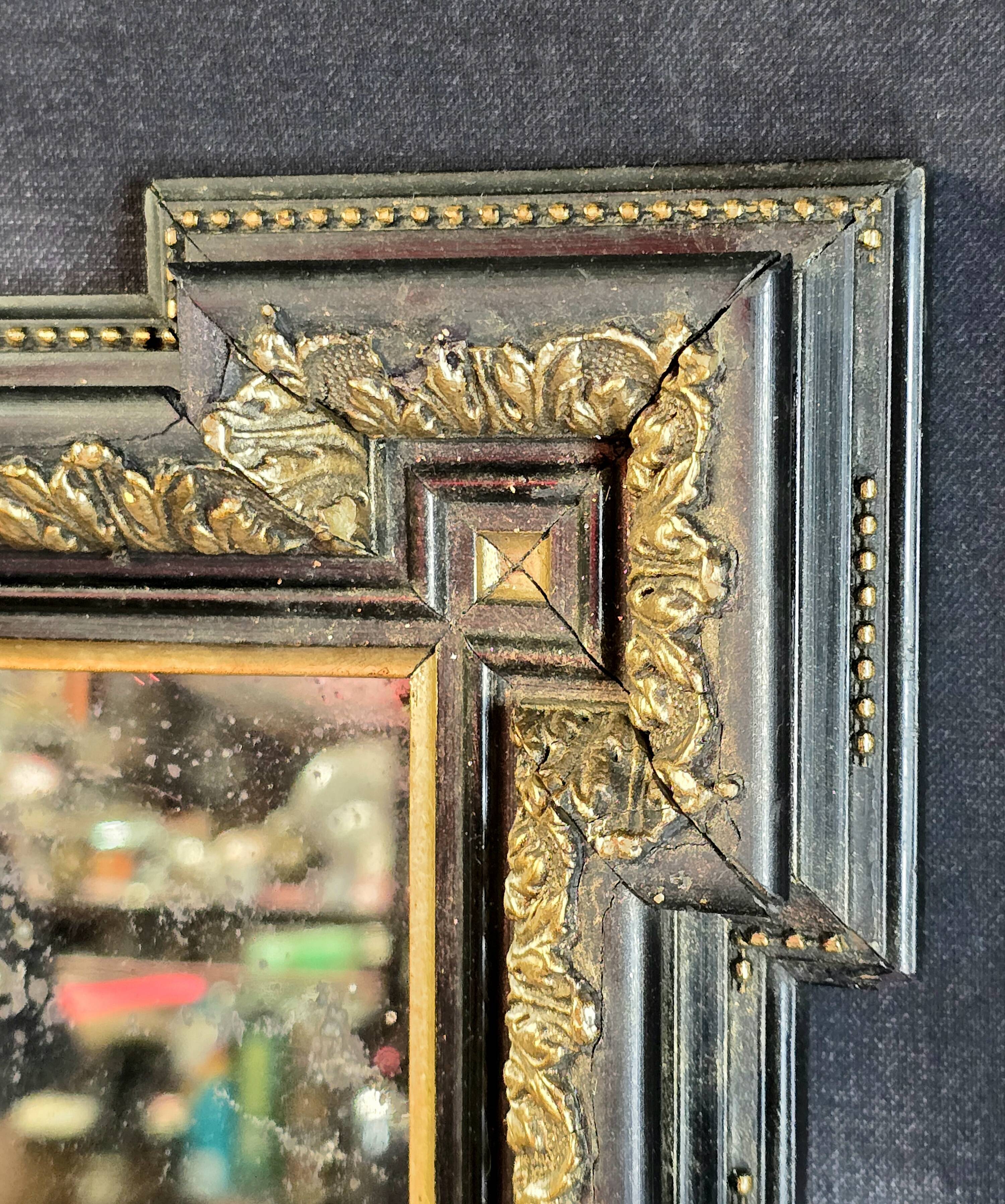 Napoleon III mirror in blackened wood and gilded decoration, second half of the 19th century.