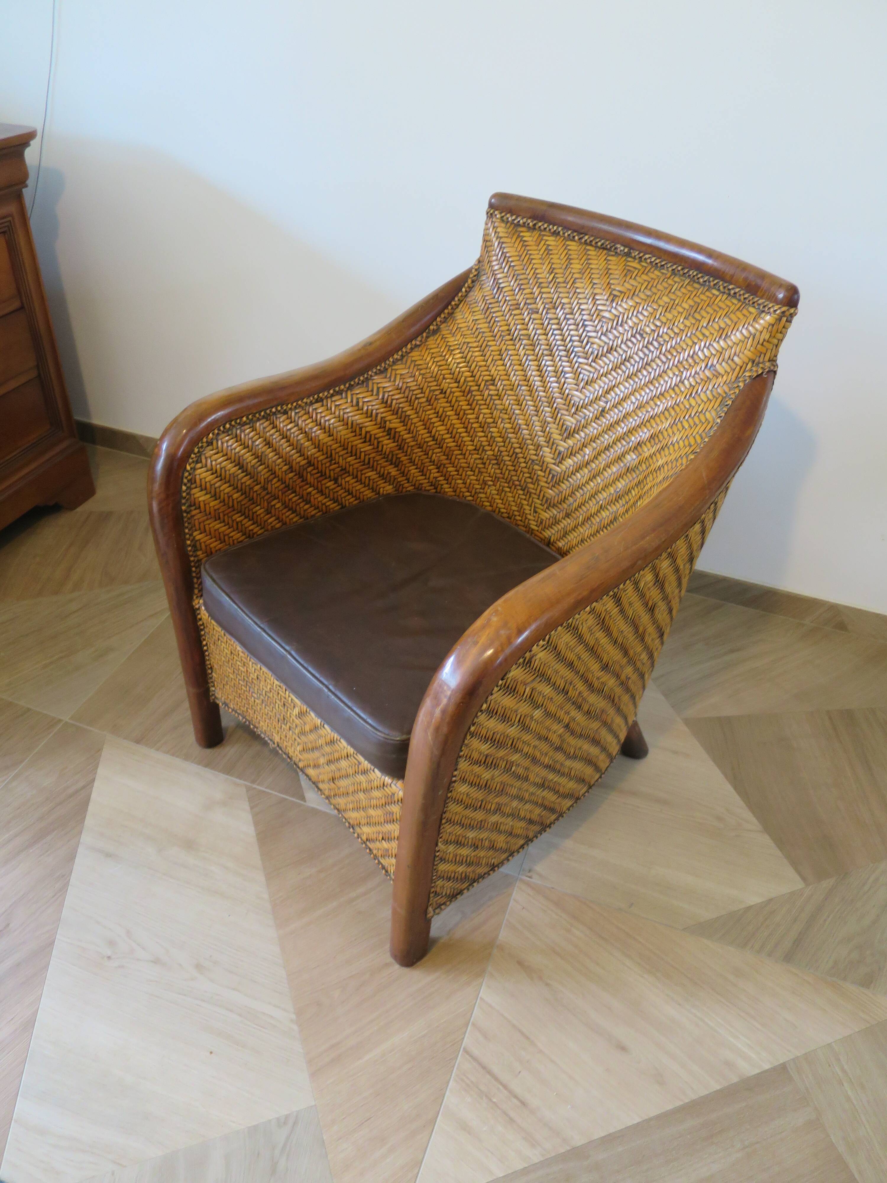 Colonial style armchair in woven rattan and exotic wood