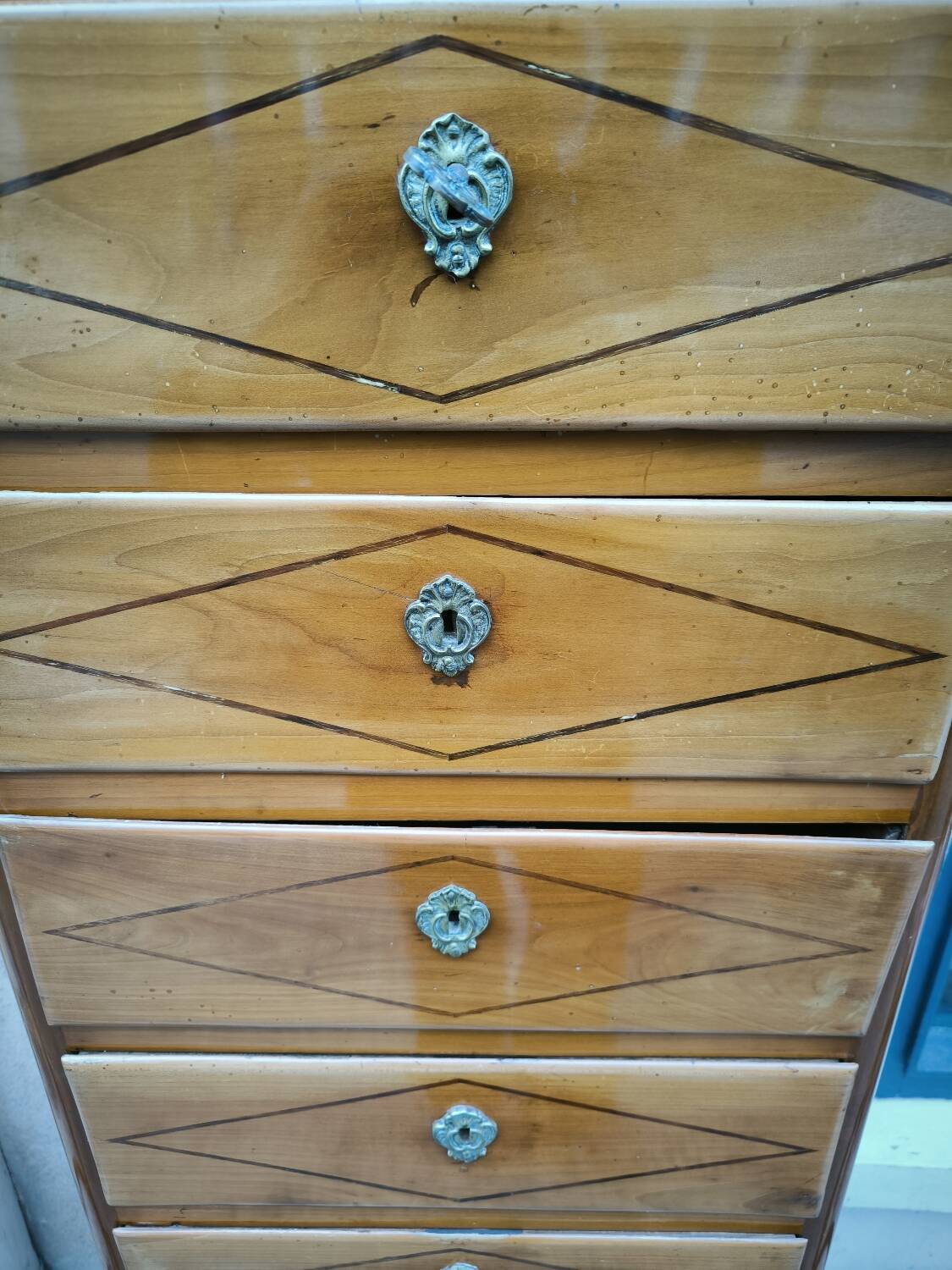 A seven-day chest of drawers in solid cherry wood with ebony stringing, 18th century