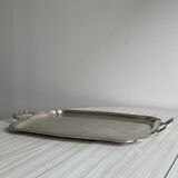 Silver metal serving tray with sculpted handles