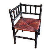 Corner chair in turned black wood and straw
