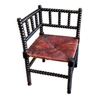 Corner chair in turned black wood and straw
