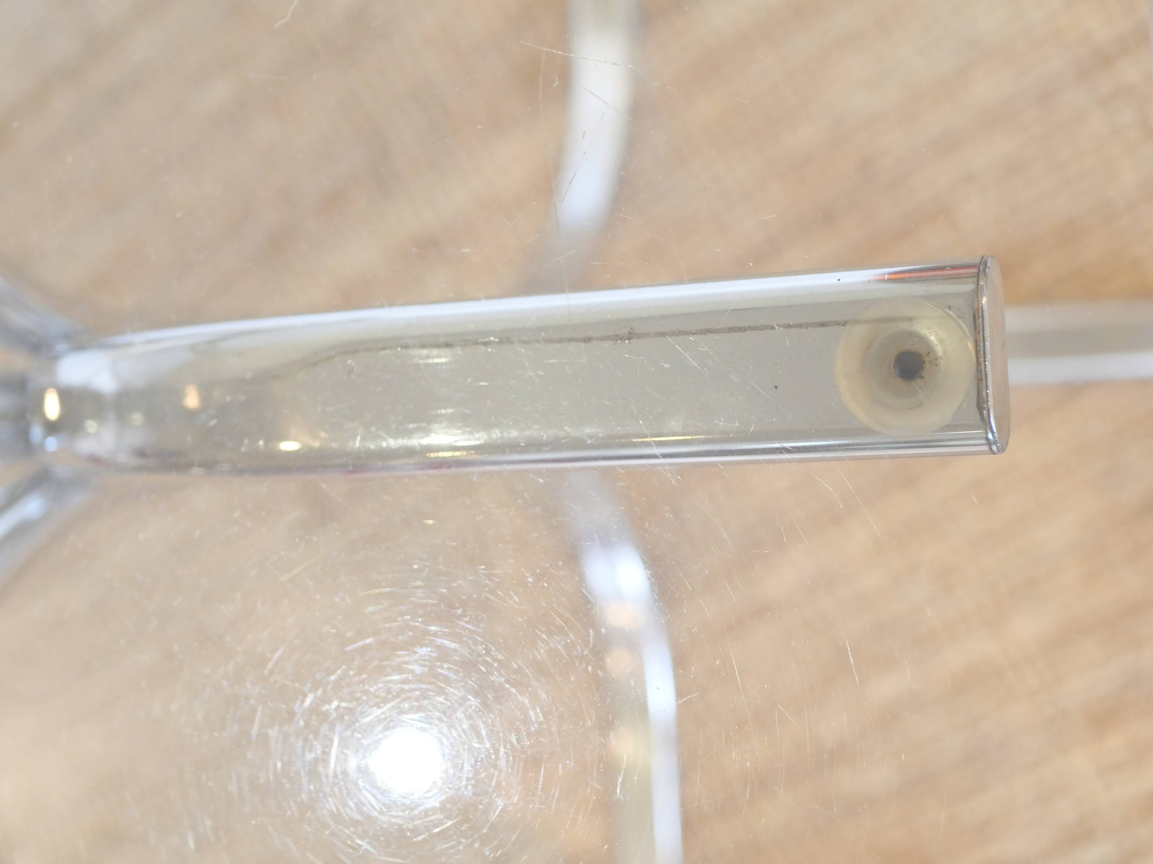 Dining table with smoked glass top and chrome base.