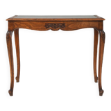 Side table with sculpted elements and rattan top