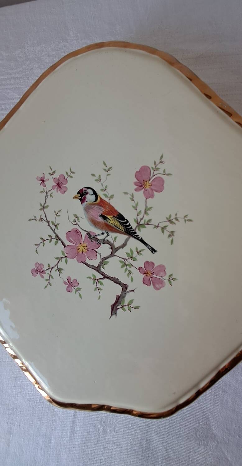 Trivet and bottle holder Salin, 1950s. Bird on branch.
