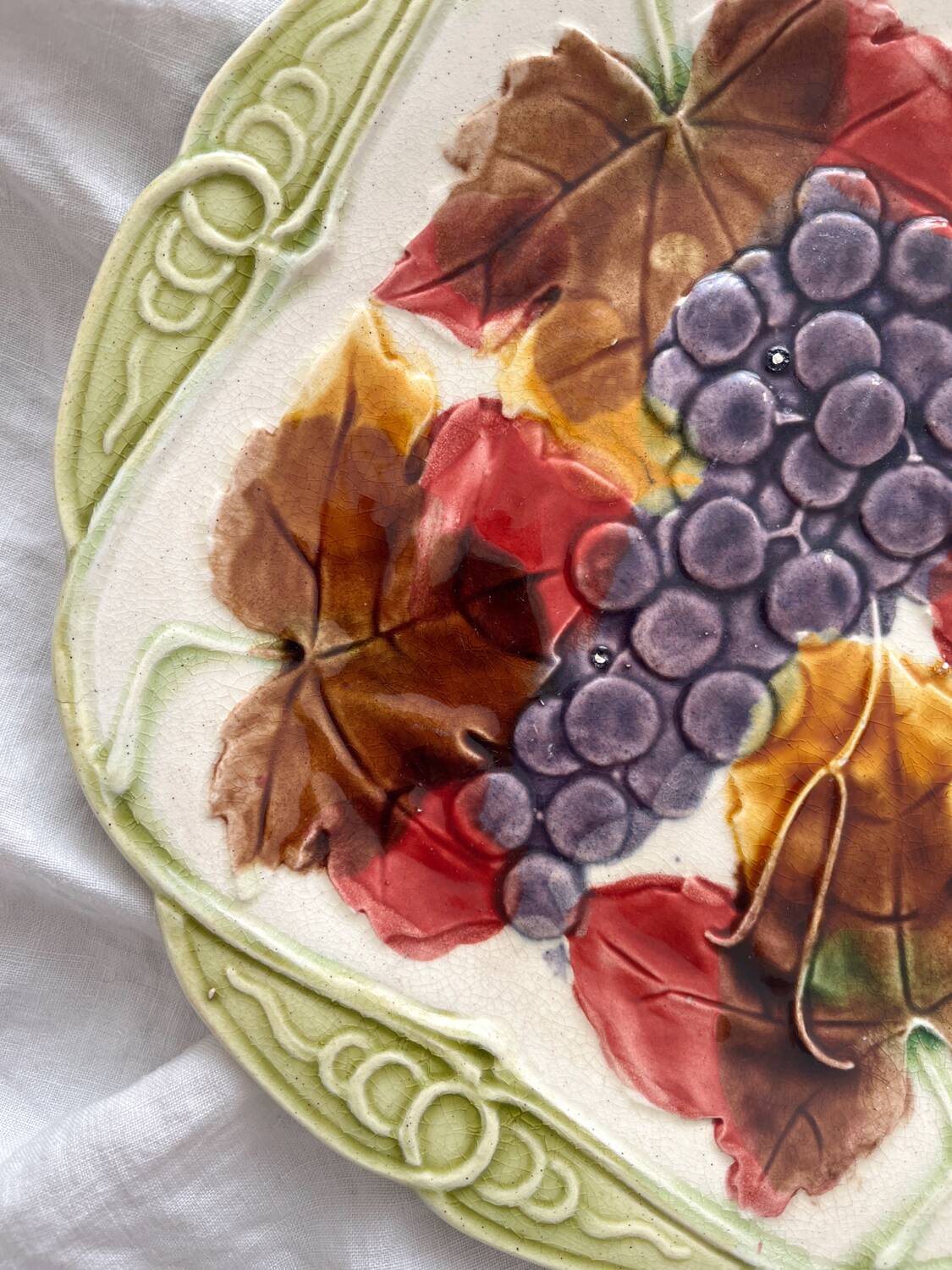 Antique plate in barbotine grapes and vine leaves from Orchies