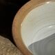 Small thick stoneware bowl with a stylised flower pattern in white on the outside, b