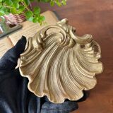 Bronze “shell” pocket emptier