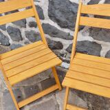 Pair of folding chairs in blond wood