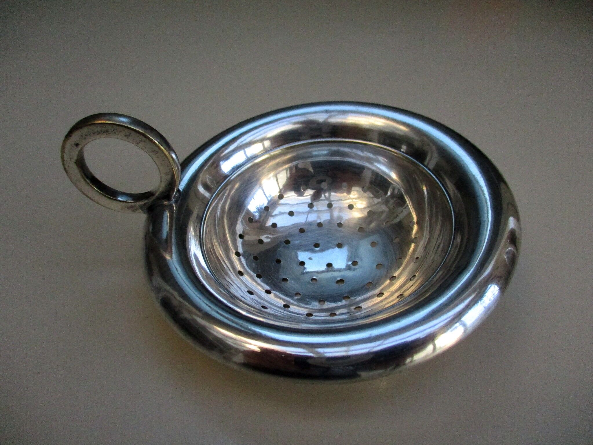 Silver metal tea strainer