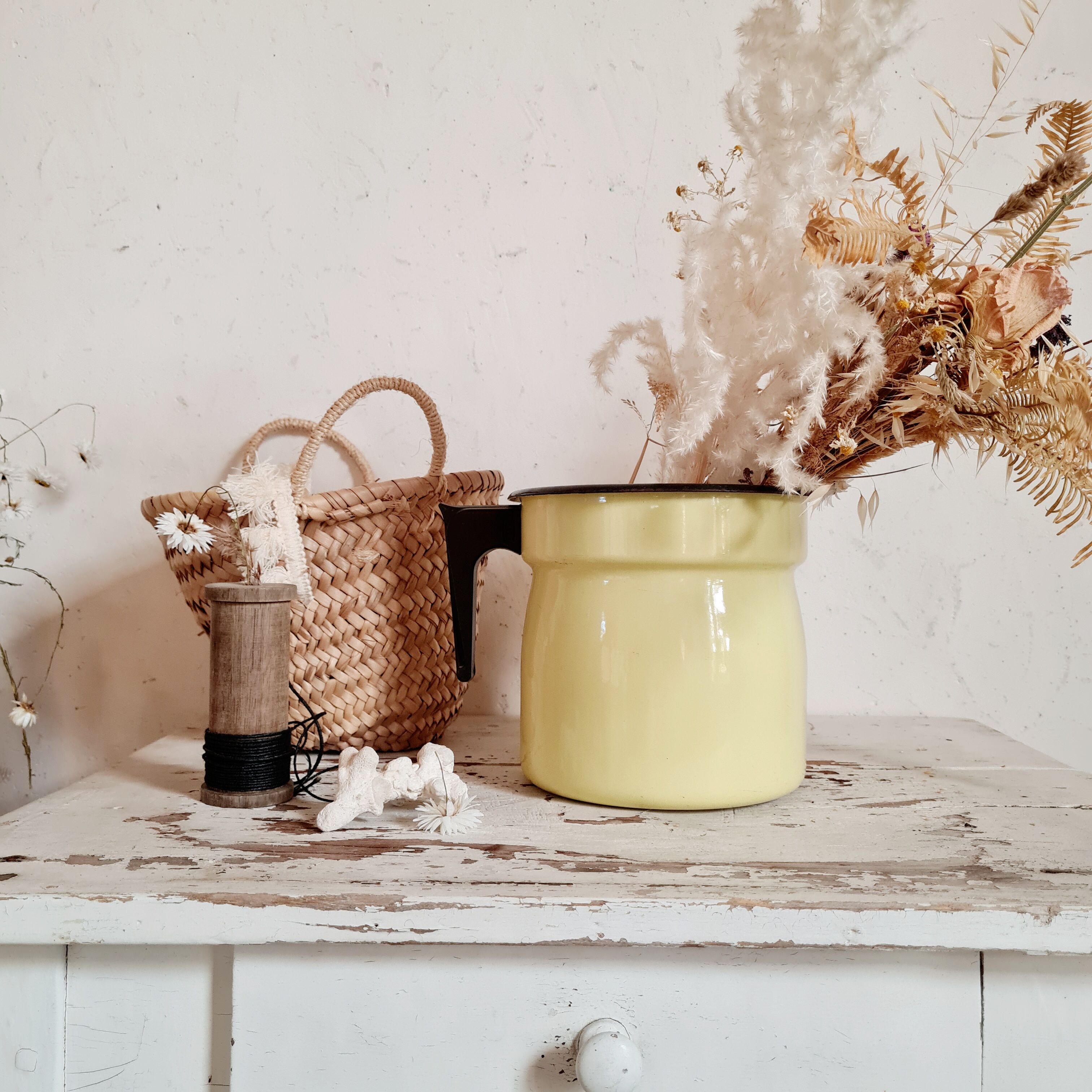 Old pitcher in yellow enamelled sheet metal