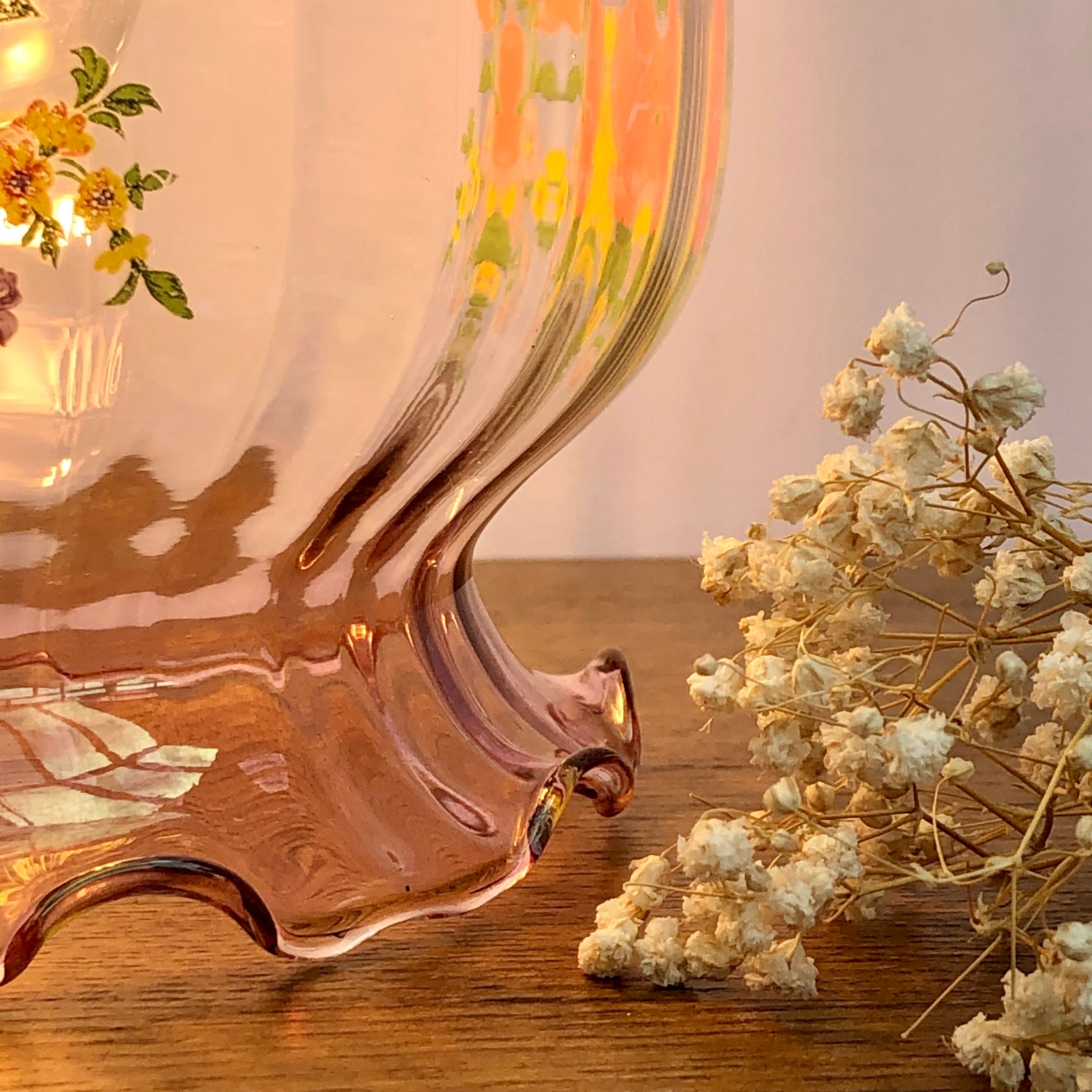 Vintage pink glass hand lamp with flower motifs